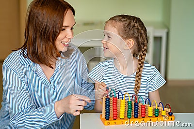 Mom with girl learning to add and subtract Stock Photo