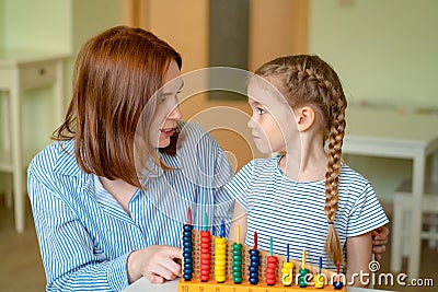 Mom with girl learning to add and subtract Stock Photo