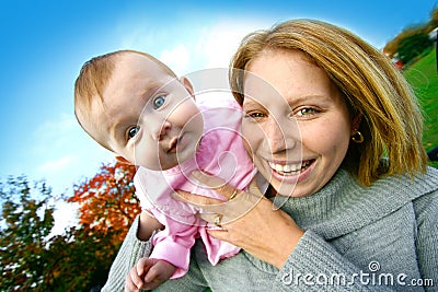 Mom with her baby girl playing outdoor. Stock Photo