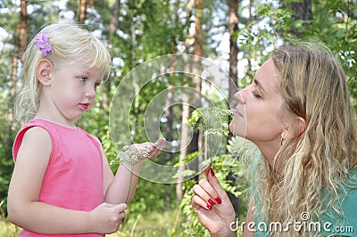 Mom with her daughter in the summer woods. Stock Photo