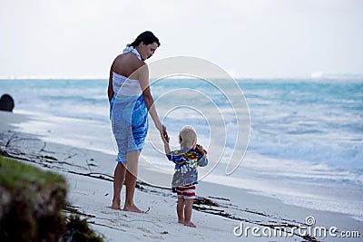 Mom, holding little toddler boy with binoculars, observing Stock Photo