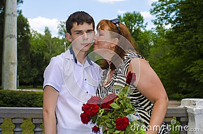 Mom intends to kiss her son. Stock Photo