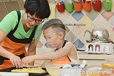 Mom and kid making pizza Stock Photo