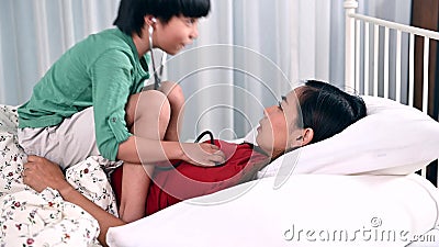Mom and Kid Playing As Doctor Together on the Bed. Woman Lifestyle and Family Activity. Asian Mother at Home with Son Stock Footage - Video of parent, house: 190959374 