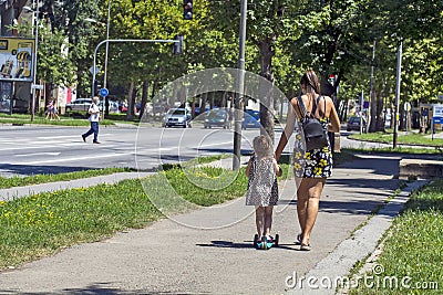 Mom and little girl on the street Editorial Stock Photo