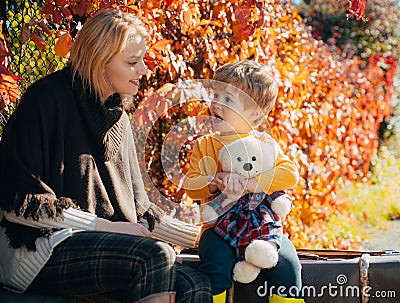 Mom little son communicate autumn foliage background. Trustful relations. Parenthood and upbringing. Love and trust Stock Photo