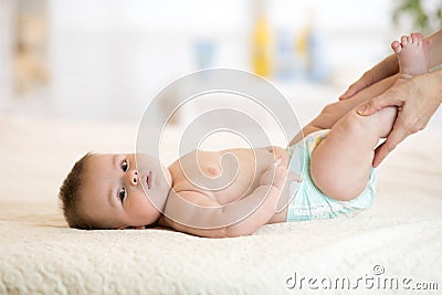 Mom or massagist doing gymnastics baby Stock Photo