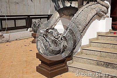 Mom mythical animal statue lanna style on stairs at Wat Phra That Doi Tung temple in Chiang Rai, Thailand Stock Photo