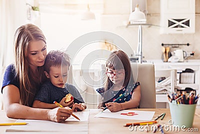 Mom drawing with her children Stock Photo