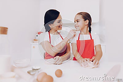 Mom Praises Little Girl for a Good Work in the Kitchen. Stock Photo