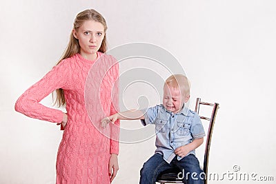 Mom punishes her naughty son Stock Photo