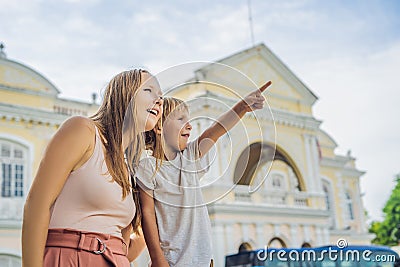 Mom and son on background of Old Town Hall in George Town in Penang, Malaysia. The foundation stone was laid in 1879 Stock Photo