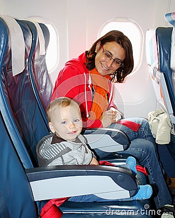 Mom and son sit inside an aircraft and ready to take off Stock Photo