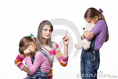 Mom talks hard with her daughter for offending her sister and looking in the frame Stock Photo