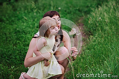 Mom throws daughter plays in sunset ligt Stock Photo