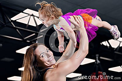 Mom throws her daughter up in the gym. Stock Photo