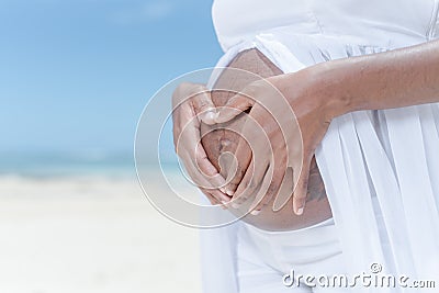 Mom to be, baby on the way, pregnant, pregnancy, beach setting. Stock Photo