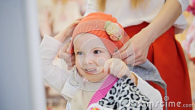 Mom wears daughter`s orange cap Stock Photo