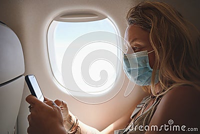 Mom wont stop texting me. a woman using her phone in the aeroplane. Stock Photo