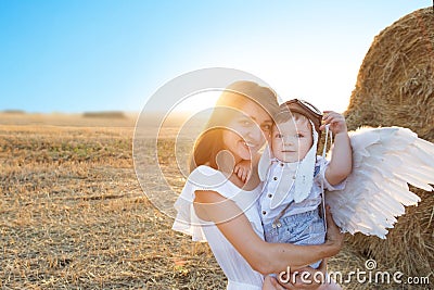 Mom and young son playing in the field Stock Photo