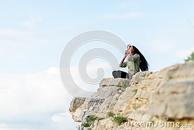 Moment of relaxing outdoor. Happy african american hipster woman with smartphone and headphones listening to music over Stock Photo