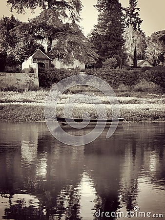 Moment of reverie. A scenic view of a small boat floating on water with reflection and a luxurious nature Stock Photo