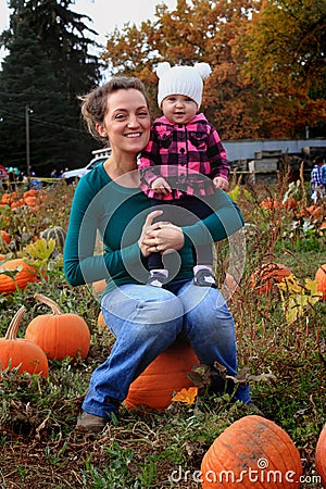 Mommie and Baby in pumpkin patch Stock Photo