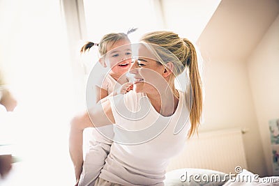 Mommy carrying me on back. Little girl. Stock Photo
