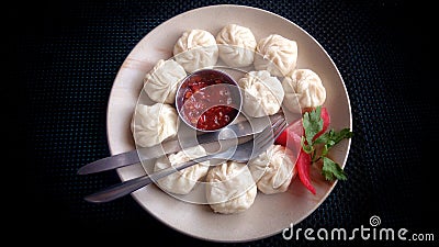 Momo on a plate with sauce Stock Photo