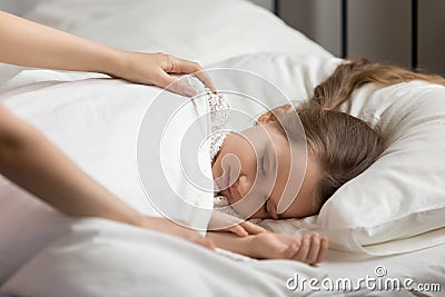 Mother mother wakes up a child daughter in the morning Stock Photo
