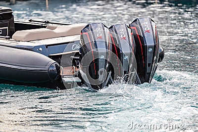 Monaco, Monte-Carlo, 27 September 2019: Three combined powerful motor engines by the rubber boat in operation, black Editorial Stock Photo