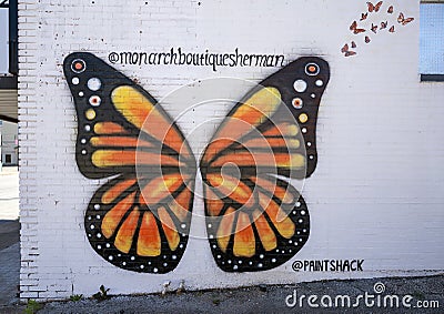 Monarch butterfly mural on an outside wall of the Monarch Boutique in historic downtown Sherman, Texas. Editorial Stock Photo