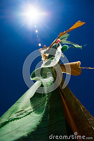 Monastery prayer flag pole in sun Stock Photo