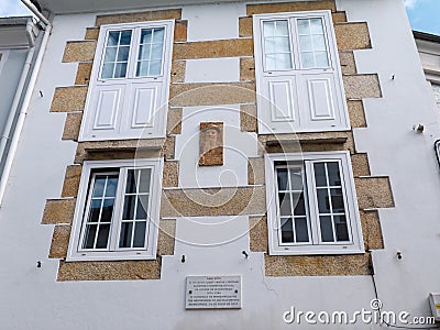 MONDONEDO, SPAIN - AUGUST 08, 2021:Marble plaque and portrait marking a home of writer,journalist and official town chronicler Editorial Stock Photo