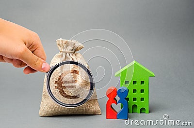 Money bag and family standing near the house. The concept of money management and property. Budget planning. Accumulation of money Stock Photo