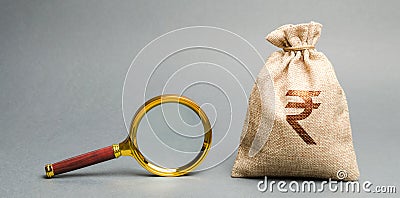 Money bag with rupee rupiah sign and magnifying glass. The concept of finding sources of investment and sponsors. Charitable Stock Photo