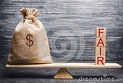 Money bag and wooden blocks with the word Fair. Balance. Fair value pricing, money debt. Fair deal. Reasonable price. Justified Stock Photo