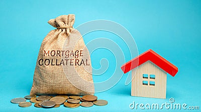 Money bag with the word Mortgage collateral and wooden house. Affordable housing programs for young families. Governmental support Stock Photo