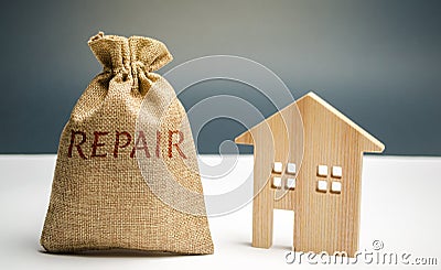 Money bag with the word repair and a wooden house. Saving and accumulation of money to repair. Concept of a new house, apartment Stock Photo