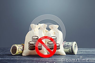 Money bags and red prohibition symbol No. Capital export outflow restrictions. Sanctions. Restriction of financial transactions. Stock Photo