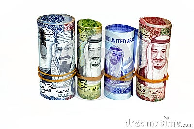 Money banknotes rolls of 50 SAR fifty Saudi Arabia riyals, 50 fifty United Emirates Dirhams banknotes and 500 five hundred riyals Stock Photo