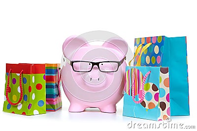 Money-box and multicolored bags Stock Photo