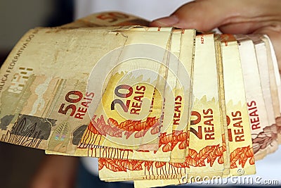 Money from brazil - several real bills on hands Stock Photo