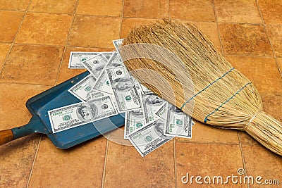 Money and broom Stock Photo