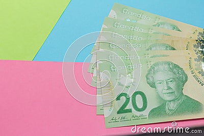 Money from Canada: Canadian Dollars. Bills on colorful bright table Editorial Stock Photo