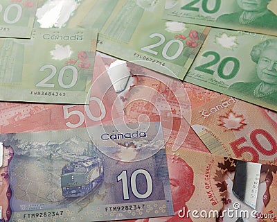 Money from Canada: Canadian Dollars. Full frame of bills spread on table and assorted amounts Editorial Stock Photo
