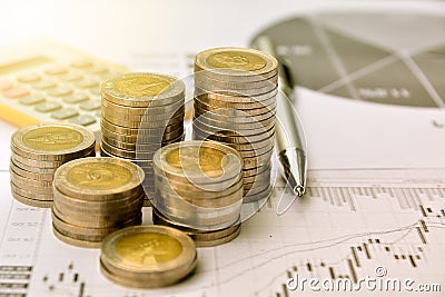 money coins with graph paper and calculator, finance and growth Stock Photo