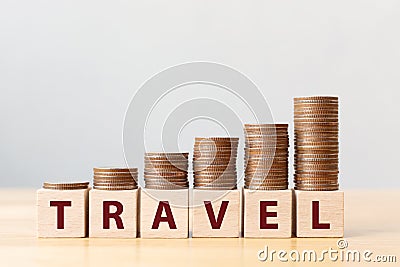 Money coins stack stair as step growing growth and wooden cube block with word TRAVEL Stock Photo