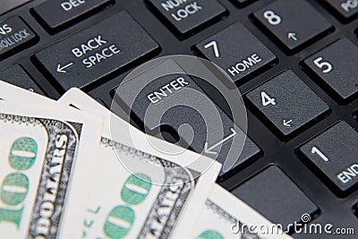 Money on computer keyboard close up Stock Photo