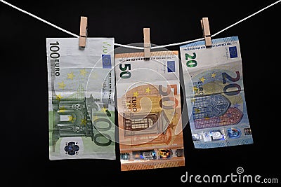 Money. Euro banknotes hanging on rope attached with clothes pins Stock Photo